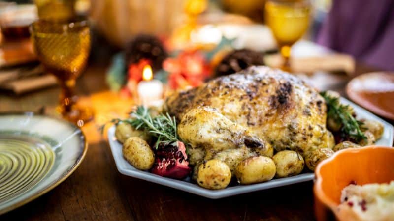 Roasted turkey with potatoes on a holiday table.