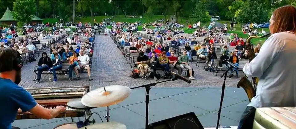 Musicians performing outdoors for a seated crowd in a Savannah park during a fall music festival
