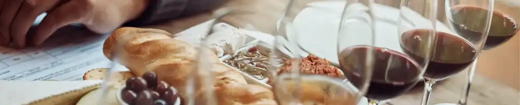 Close-up of bread, olives, and wine glasses for a Savannah wine tasting guide